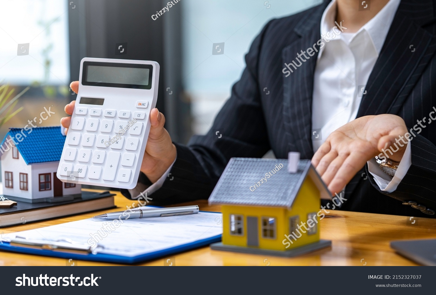 Stock photo real estate agents offer home equity loans to their customers to decide to insure their rental 2152327037 1